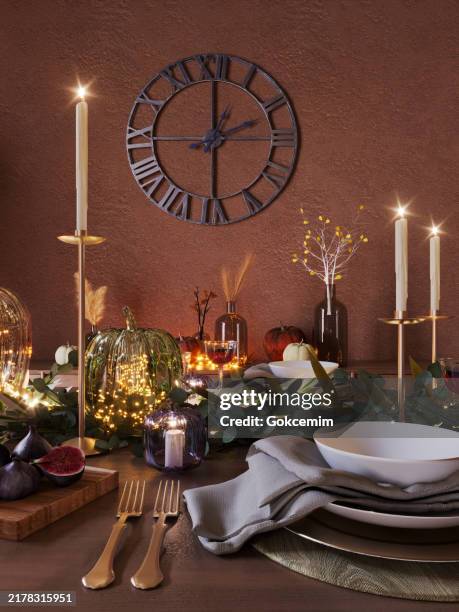 autumn thanksgiving dining table setting on a wooden rustic table. fall table decoration with pumpkins, branches, berries, candles and wine. - rustic dinner party stock pictures, royalty-free photos & images