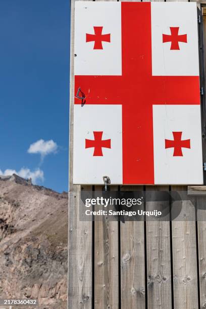 georgian flag at altihut mountain refuge - georgia flag stock pictures, royalty-free photos & images