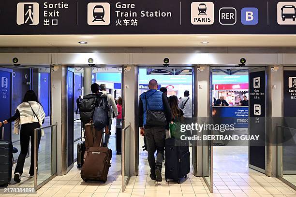 Passenger exit a terminal on the sidelines of a visit by the French minister for Budget and Public Accounts at the Roissy-Charles de Gaulle airport,...