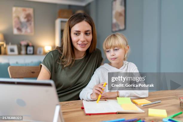 mother helping daughter study from home - human role stock pictures, royalty-free photos & images