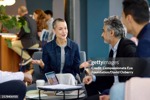 business colleagues having informal meeting - differential focus stock pictures, royalty-free photos & images