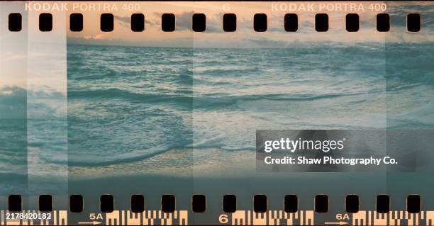 film photo of water at beach with sprockets - film reel stock pictures, royalty-free photos & images
