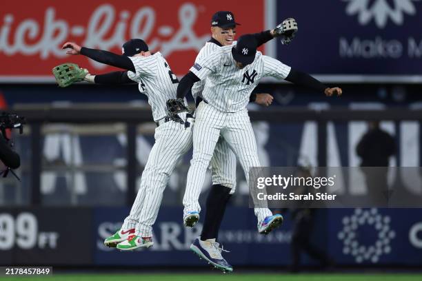 Outfielders Alex Verdugo, Aaron Judge and Juan Soto of the New York Yankees celebrate as the Yankees win Game One of the American League Championship...