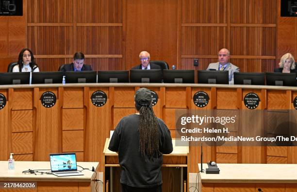 Robert Lewis, father of shooting victim Kilyn Lewis, addresses Aurora Mayor Mike Coffman and other members of the Aurora City Council during their...