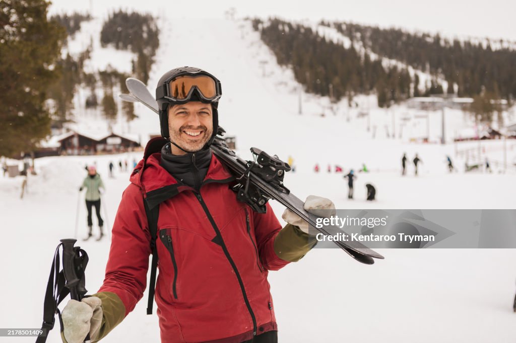 Portrait of a man in ski equipment, at a ski resort.