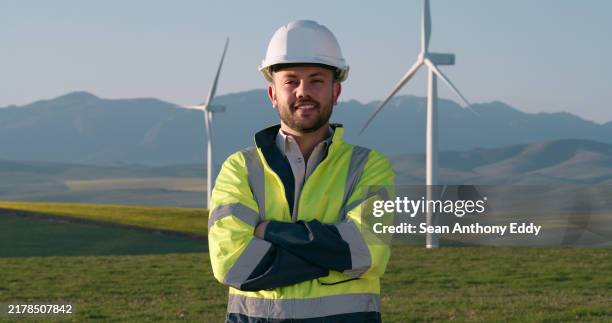 crossed arms, man and engineer by windmill farm for renewable energy maintenance or repairs. sustainable, confident and portrait of industrial worker with wind turbines for electricity. - environmentalist stock pictures, royalty-free photos & images
