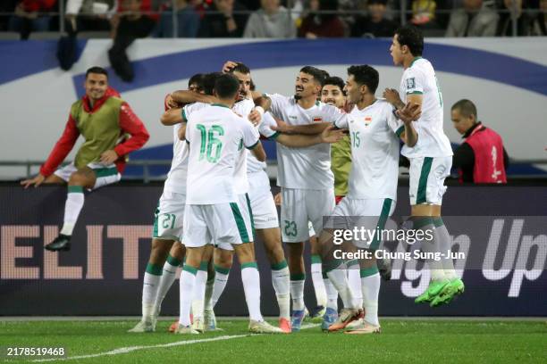 Aymen Hussein of Iraq celebrates after scoring the team's first goal with teammate during the FIFA World Cup Asian Third Qualifier Group B match...