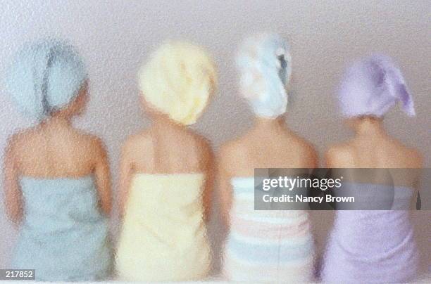 back view of four towel-wrapped women - woman with towel spa stock pictures, royalty-free photos & images