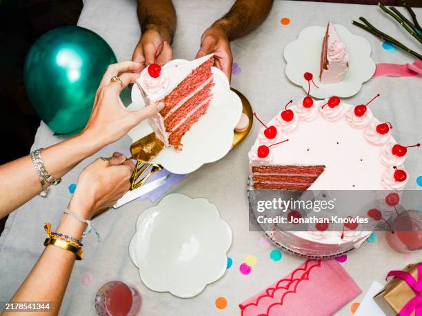 woman slicing and serving cherry birthday cake at birthday party - cake stock pictures, royalty-free photos & images