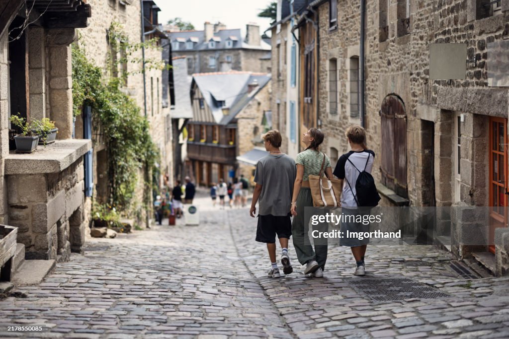 Teenagers walking in the old town of Dinan, Brittany, France.