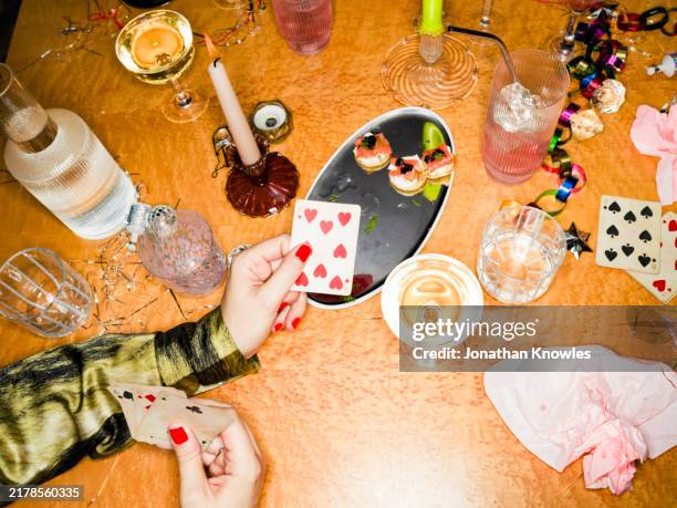 woman playing poker and drinking champagne at new year's eve party - playing card stock pictures, royalty-free photos & images