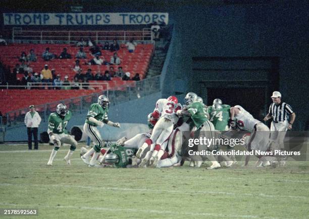 American football player Herschel Walker , of the United States Football League team New Jersey Generals, carries a ball during a game against the...