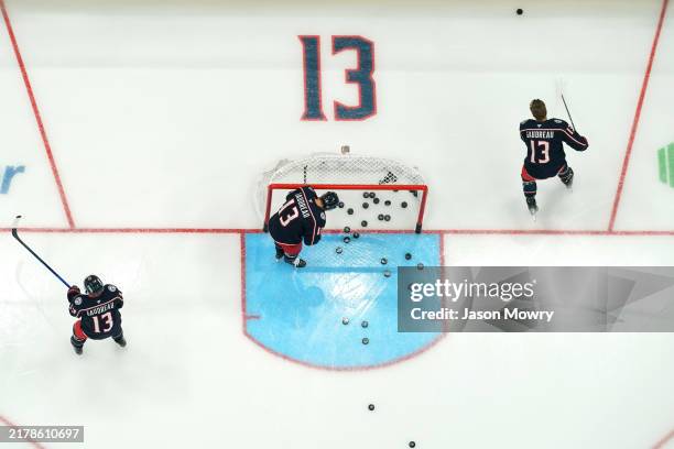 Columbus Blue Jackets players warm up before the game against the Florida Panthers at Nationwide Arena on October 15, 2024 in Columbus, Ohio. Players...
