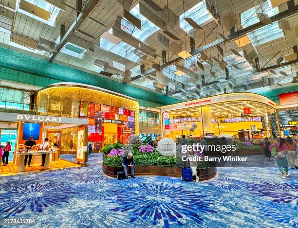 people relaxing near shops at changi airport, singapore - changi airport stock pictures, royalty-free photos & images
