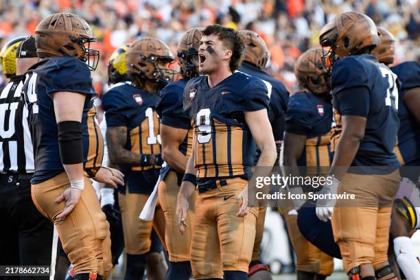 Illinois Fighting Illini Quarterback Luke Altmyer celebrates after scoring a touchdown during the college football game between the Michigan...