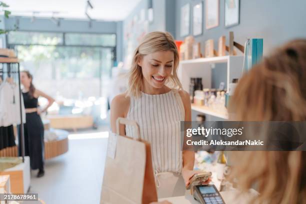 woman at the souvenir shop cashier" - souvenir collection stock pictures, royalty-free photos & images
