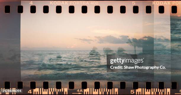 double exposure photo of water taken on film with sprockets - fotorolletje stockfoto's en -beelden