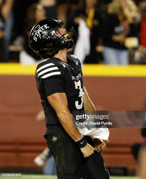 Quarterback Rocco Becht of the Iowa State Cyclones reacts after diving into the end zone to score on a two-point conversion play in the second half...