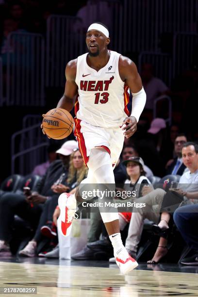Bam Adebayo of the Miami Heat dribbles the ball against the San Antonio Spurs during the first quarter of a preseason game at Kaseya Center on...