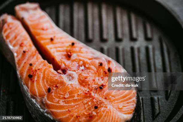 delicious raw salmon with vegetables on frying pan. ready for grill - lachssteak stock-fotos und bilder