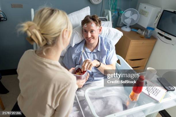 gifting a friend grapes in hospital - sympathetic nerve stock pictures, royalty-free photos & images