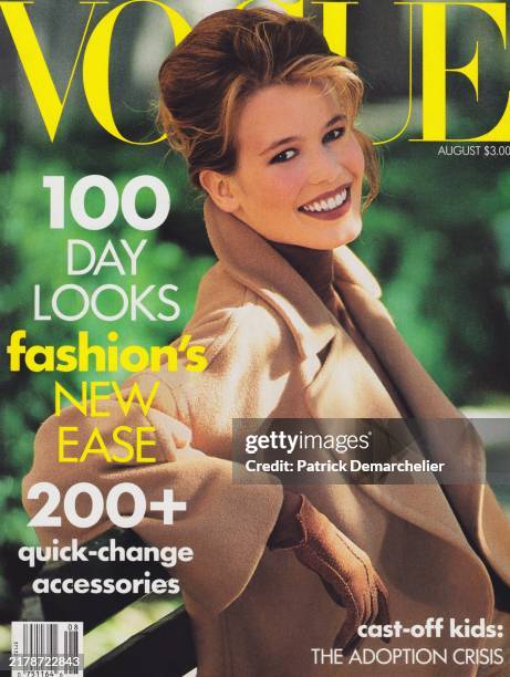 Vogue August 1990 Cover featuring: Model Claudia Schiffer in a brown coat, turtleneck, pants, and gloves, all by Calvin Klein.