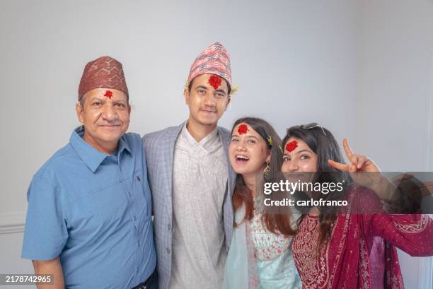 happy dashain - indoor family photo - nepalese americans celebrating - nepal’s most important holiday - joy - nepal culture stock pictures, royalty-free photos & images