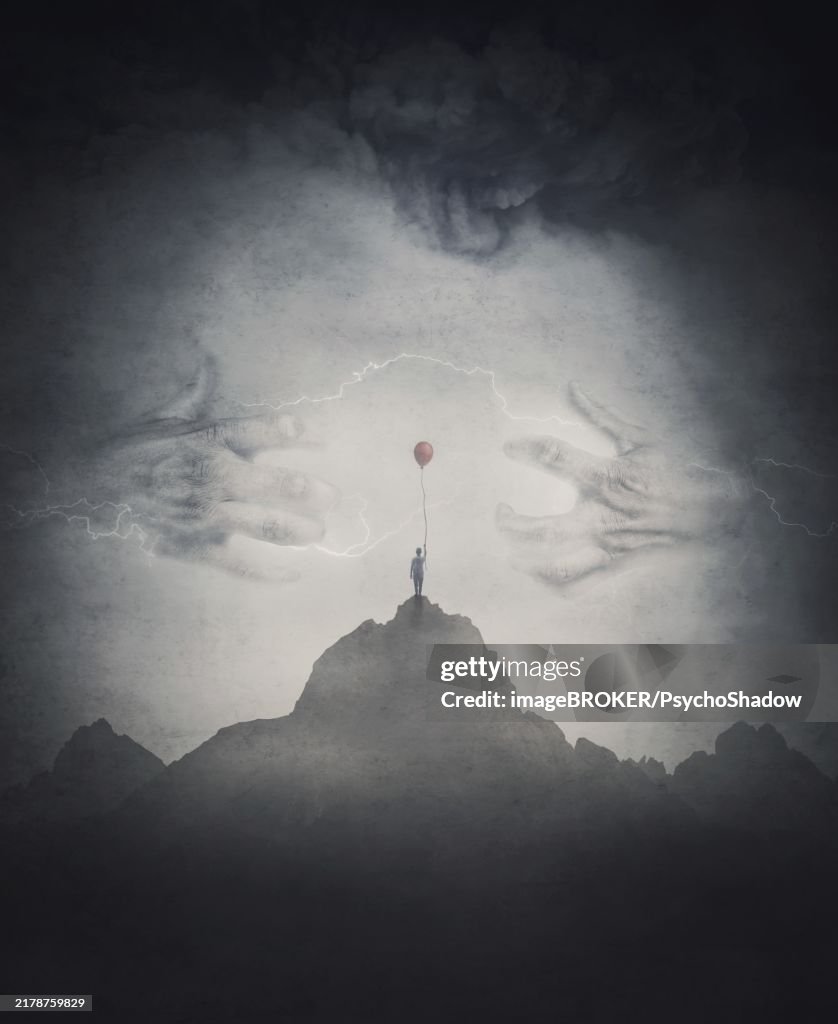 Spooky scene with a lone boy holding a red balloon on top of a mountain facing a mysterious creature with giant scary hands coming out of the fog. Fantasy adventure and thrill background