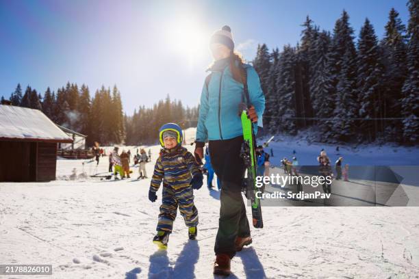 mom and son on a ski vacation - ski wear stock pictures, royalty-free photos & images