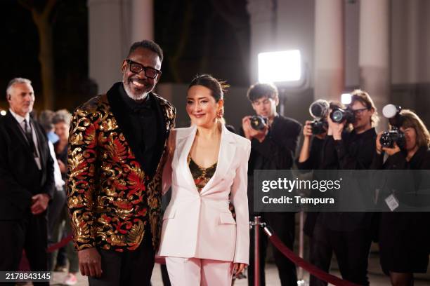 the leading actor and actress from the cast stand confidently, posing for the paparazzi as flashes light up the red carpet. - film premiere stock pictures, royalty-free photos & images