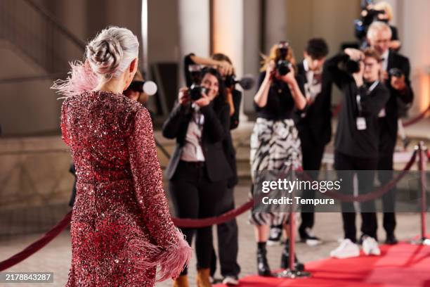 with a broad smile, the movie star greets her fans - red carpet paparazzi stock pictures, royalty-free photos & images