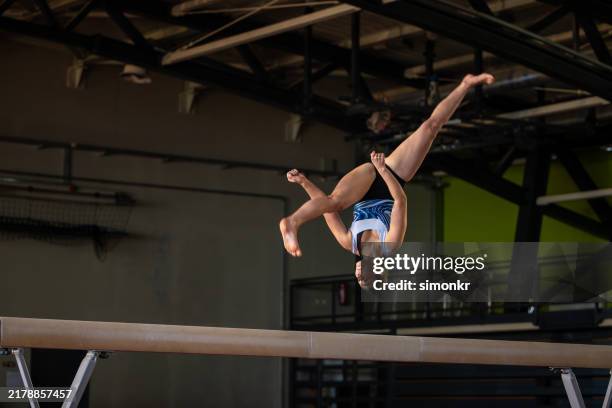 gymnast woman performing on balance beam - acrobatic activity stock pictures, royalty-free photos & images