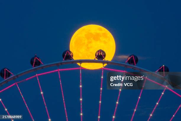 The full hunter's moon rises in the night sky on October 17, 2024 in Foshan, Guangdong Province of China. The hunter's moon is the first full moon...