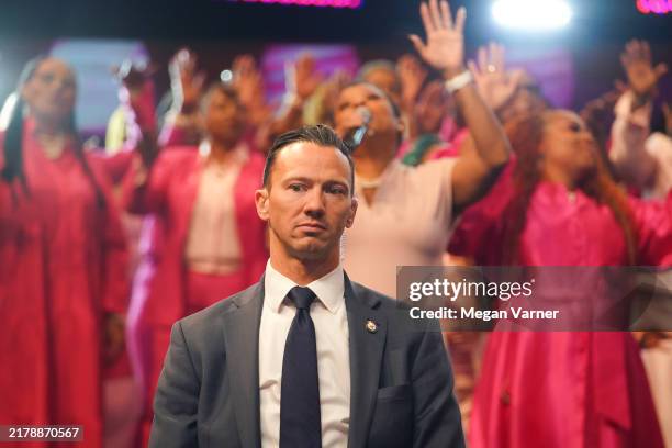 Secret Service agent stands guard as Democratic presidential nominee, U.S. Vice President Kamala Harris attends a church service at New Birth...