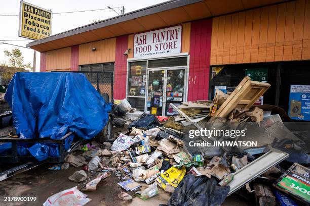 Debris covers the parking lot next to a destroyed business in Asheville, North Carolina, on October 20 as clean-up efforts continue after Hurricane...