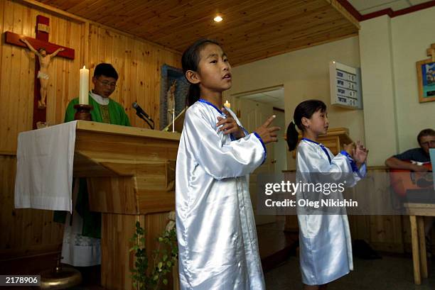 Catholic Mongolian girls participate in a mass at St. Mary's Church July 20, 2003 in Ulan Bator, Mongolia. After the Catholic mission appeared in...