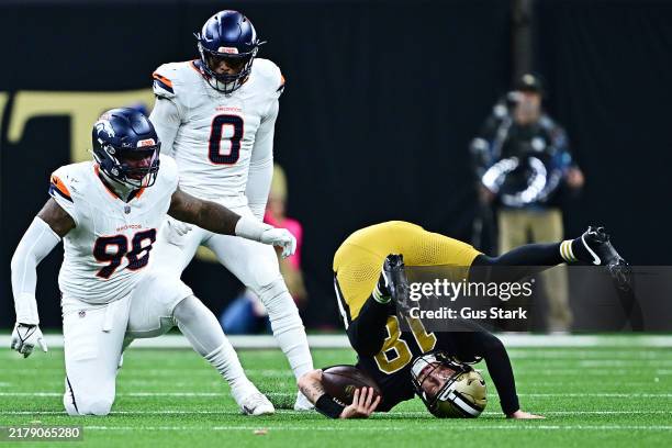Spencer Rattler of the New Orleans Saints is sacked by John Franklin-Myers of the Denver Broncos during the third quarter at Caesars Superdome on...