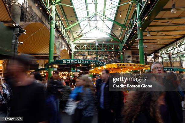 London, England Tourists walk through London's Borough Market.