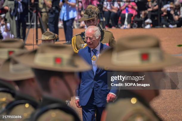 King Charles is seen walking towards the Australian troops during the ceremonial welcome. King Charles and Queen Camilla received a ceremonial...