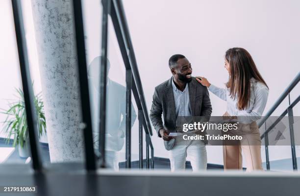 business colleagues talking on stairs in the office. - a escada do sucesso imagens e fotografias de stock