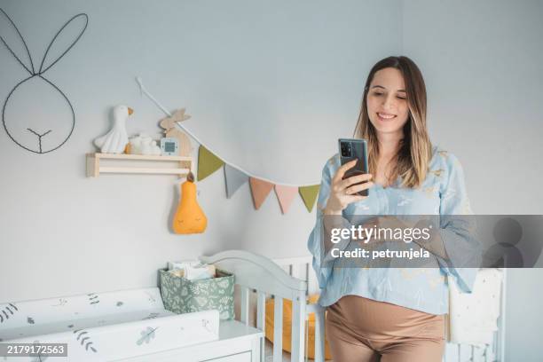 young woman enjoying in pregnancy - kinderkamer stockfoto's en -beelden