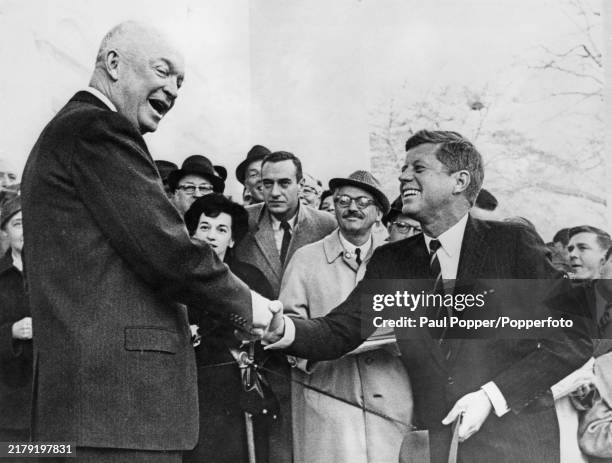 From left, President Dwight D Eisenhower and American Democratic Party politician John Fitzgerald Kennedy , President Elect of the United States,...