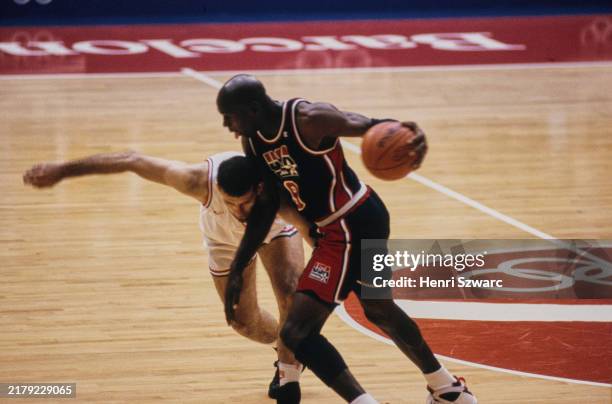American basketball player Michael Jordan under pressure from a Croatian basketball player during the men's basketball Gold Medal match between...