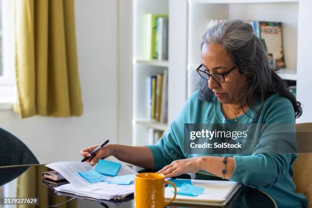 going through all the finance documents - ethnicity stock pictures, royalty-free photos & images