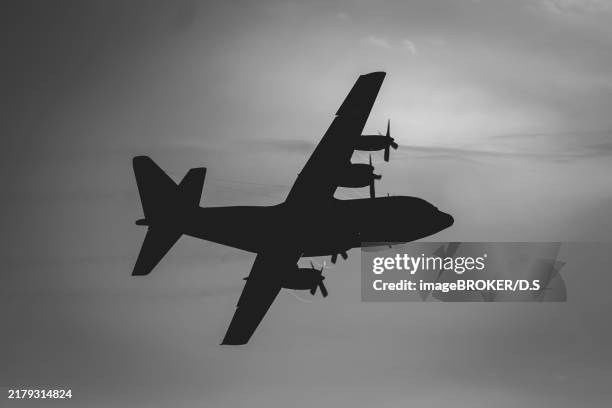 c-130 hercules large military plane in the sky - c 130 hercules stock illustrations