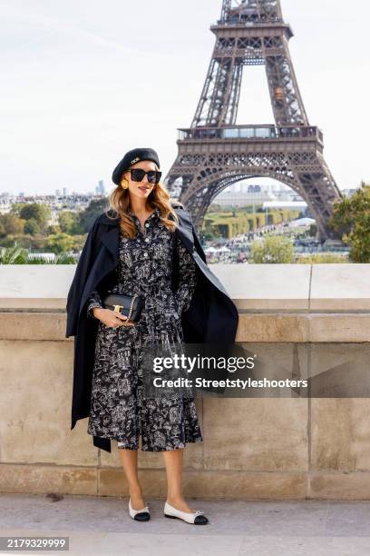 Influencer Alexandra Lapp, wearing a black dress with white printings by Alexandra Lapp x Seidensticker, a black trenchcoat-dress by Alexandra Lapp x...