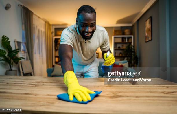 young man cleaning his home - obsessive compulsive disorder stock pictures, royalty-free photos & images