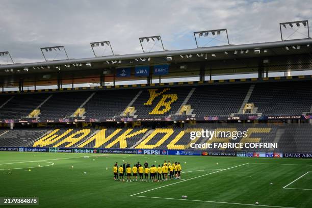 Young Boys' players listen to their headcoach during a training session ahead of the Champions League football match between Young Boys and Inter...
