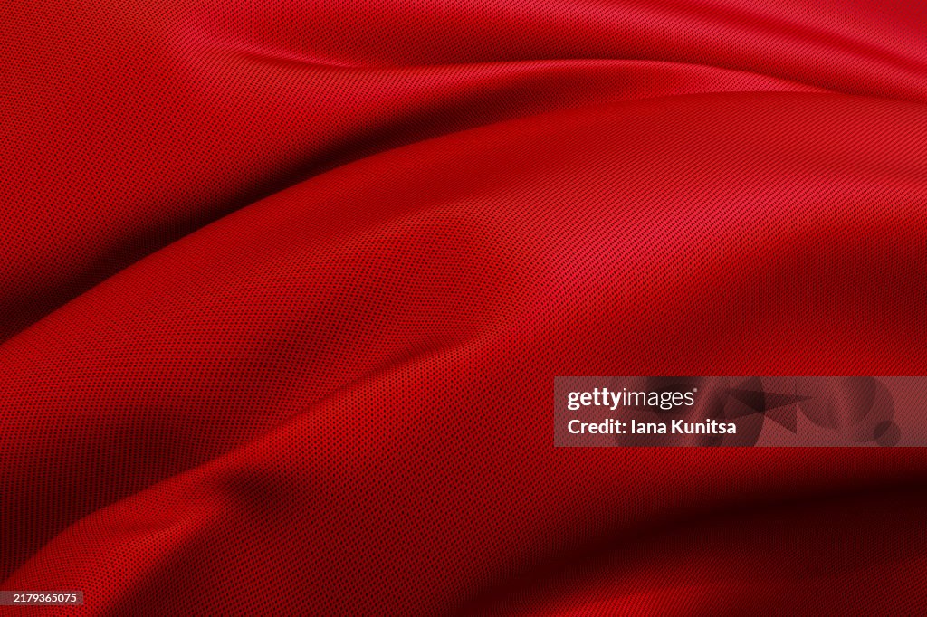 Elegant bright red satin fabric close-up background. Abstract textile texture, 3D pattern, composition. Design element.