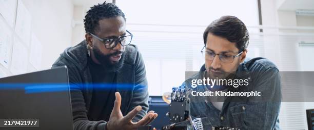 black and white male software developer programmers work together on robot hand machine coding, use computer control robotic arm circuit. programming language, hardware development technology concept - computer hardware engineer stock pictures, royalty-free photos & images